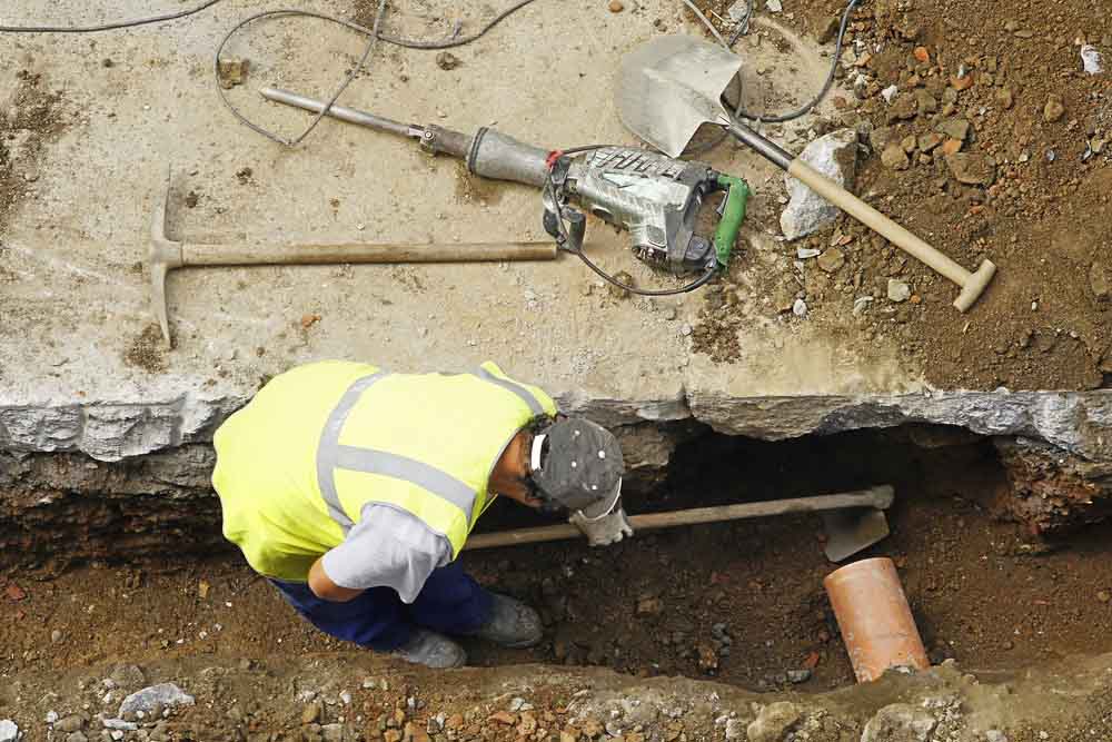 plumbing team repairing a broken sewer line