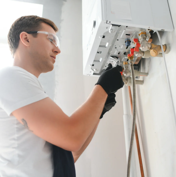 Plumber testing a water heater thermostat with a multimeter during a no-hot-water call in an Idaho home.