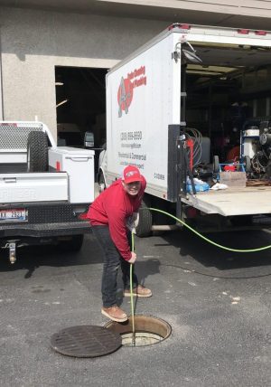 Plumber hydro-jetting a main sewer line to prevent storm-related backups in a Boise home